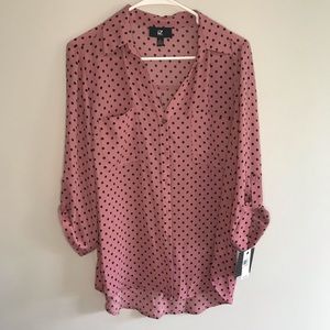 Pink blouse with small black dots.